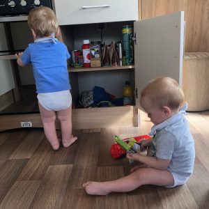 Toddlers going through the cupboards  on holiday