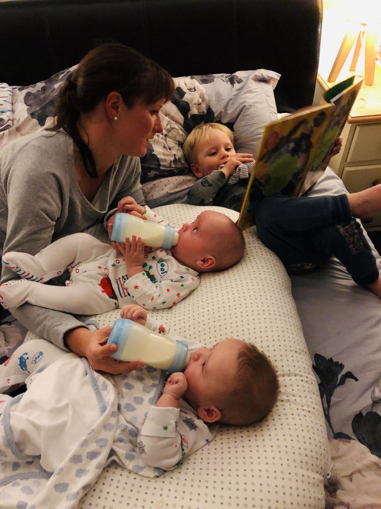 Tandem feeding twins whilst reading toddler a story