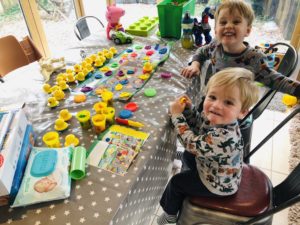 Daddy does play doh with toddlers on a weekend home alone