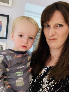 Snotty twin wants a cuddle when mum is dressed up