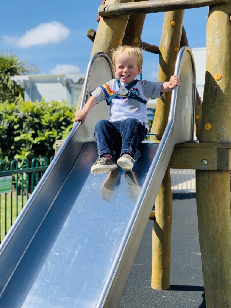 Toby on the slide at the adventure playground