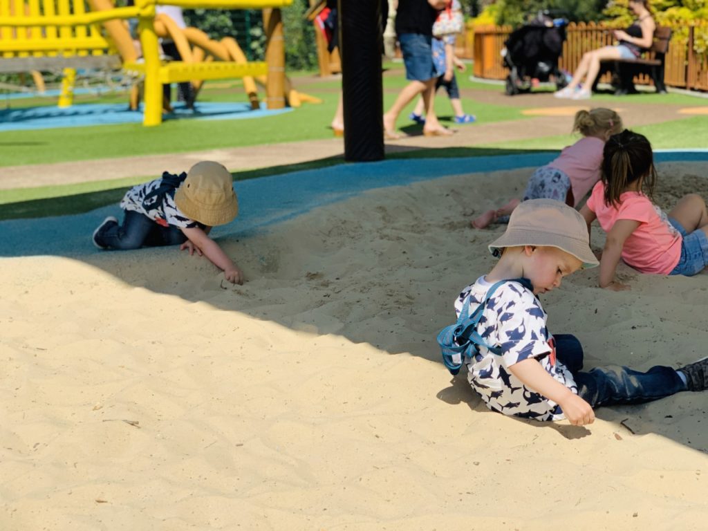 Twins play in the sandpit at Paultons Park