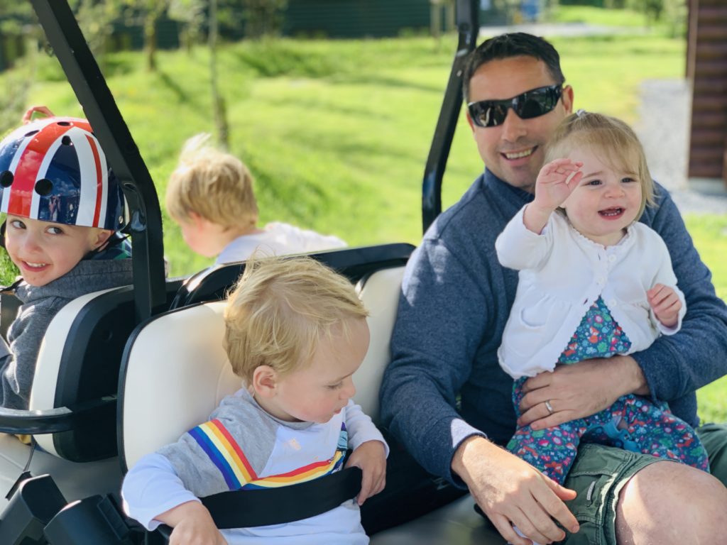 Family on a golf buggy at Bluestone