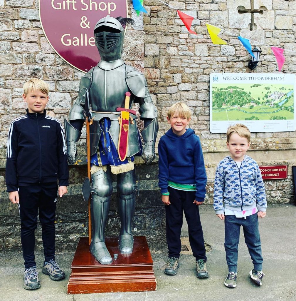 Cousins next to a knight's armour