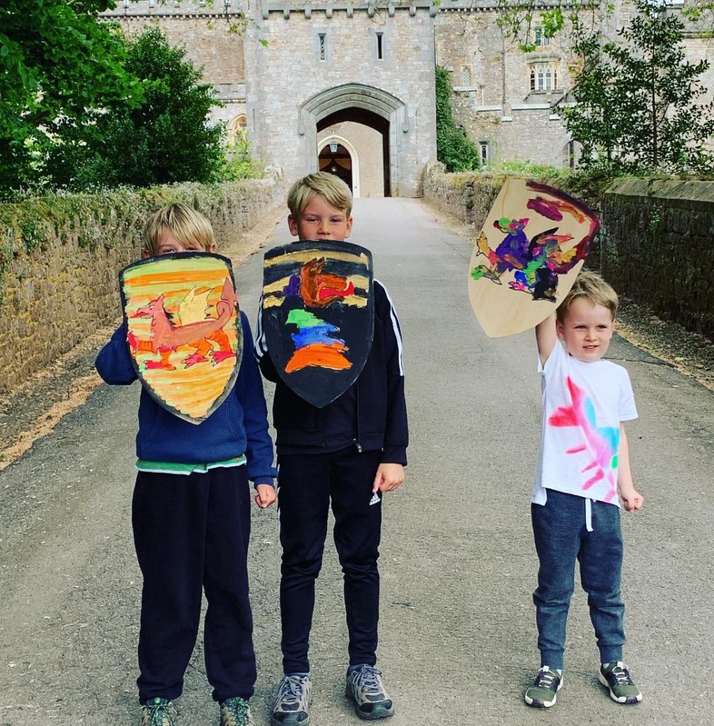 Showing off the shields they painted at Powderham