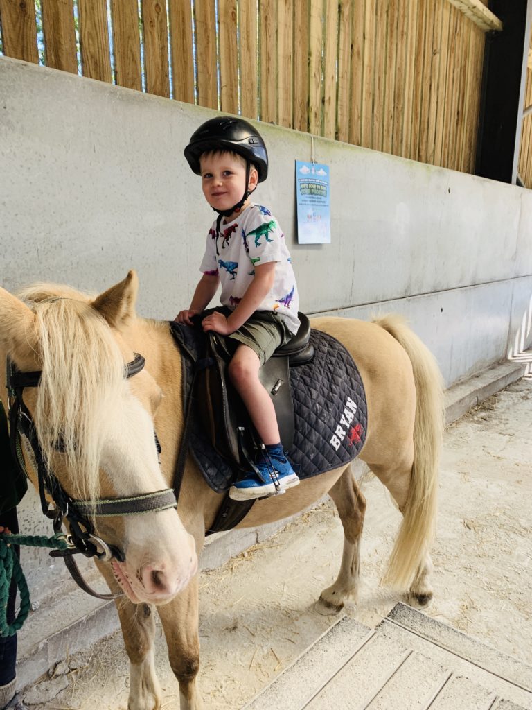 Four year old on a pony ride at Farmer Palmer's Farm Park