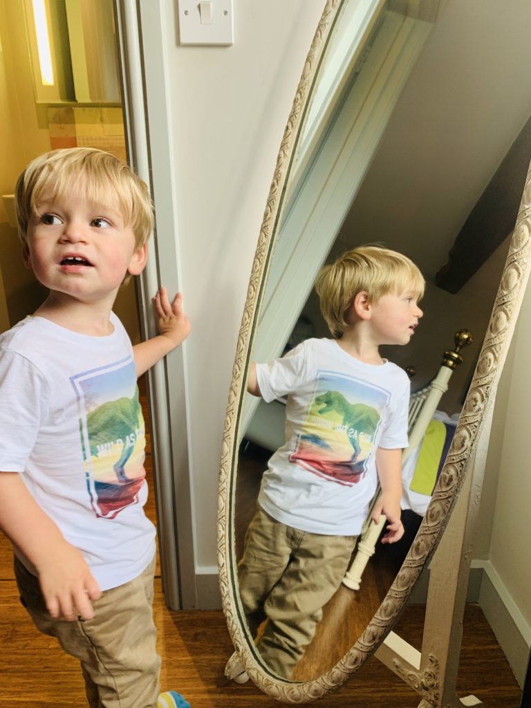 Toddler looking in the mirror at Greenwood Grange