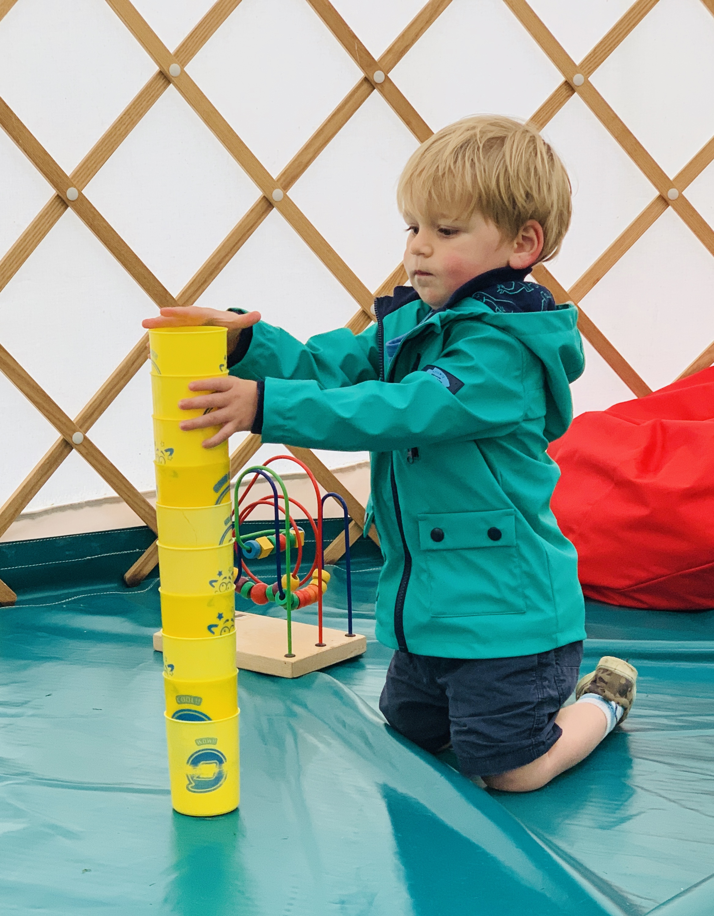 Toddler in the Greenwood Grange play yurt