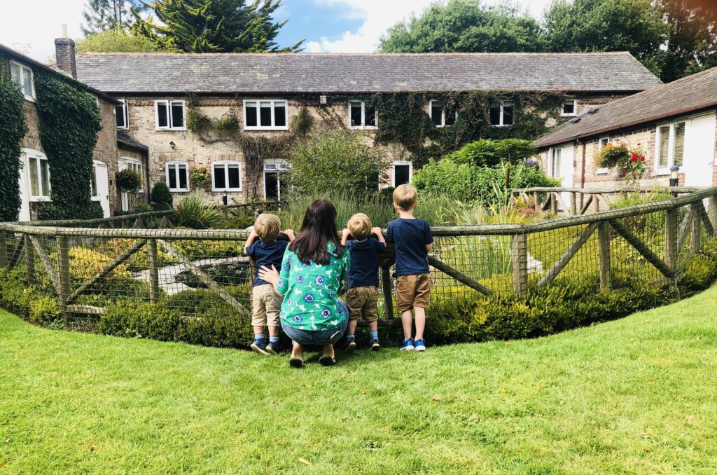 Mum and boys at Greenwood Grange fish pond from list of UK family holidays ideas