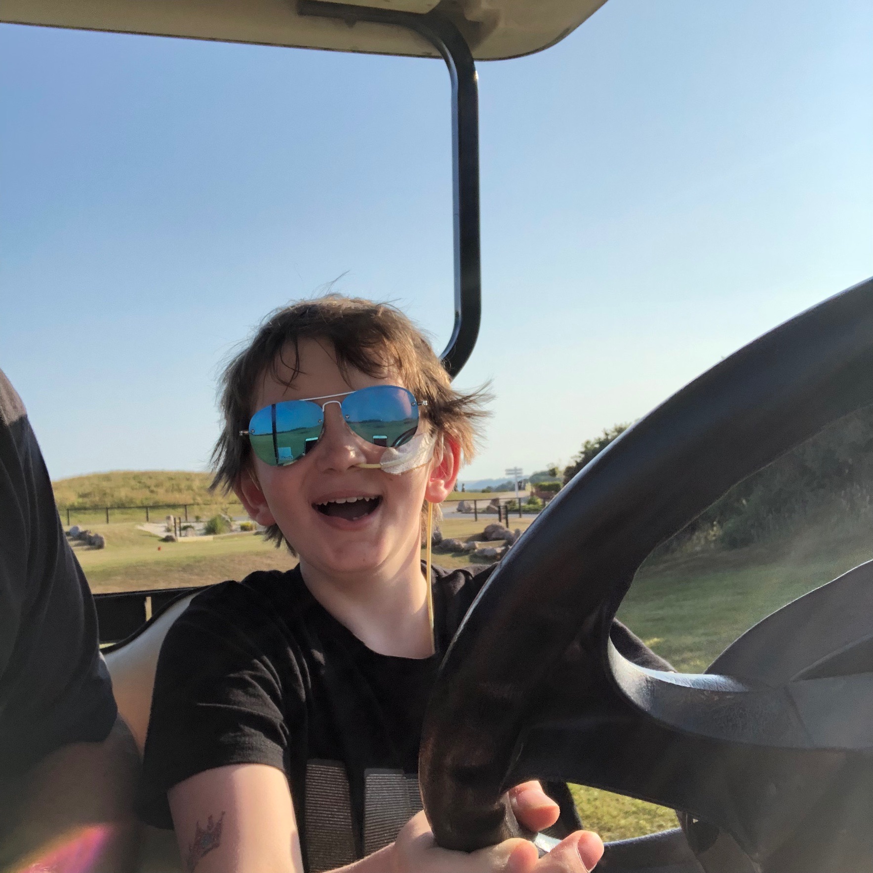 Oliver on a golf buggy