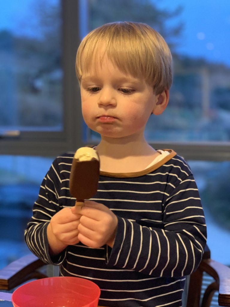 Toddler eating an ice cream at Tewynn eco lodge, The Park Cornwall