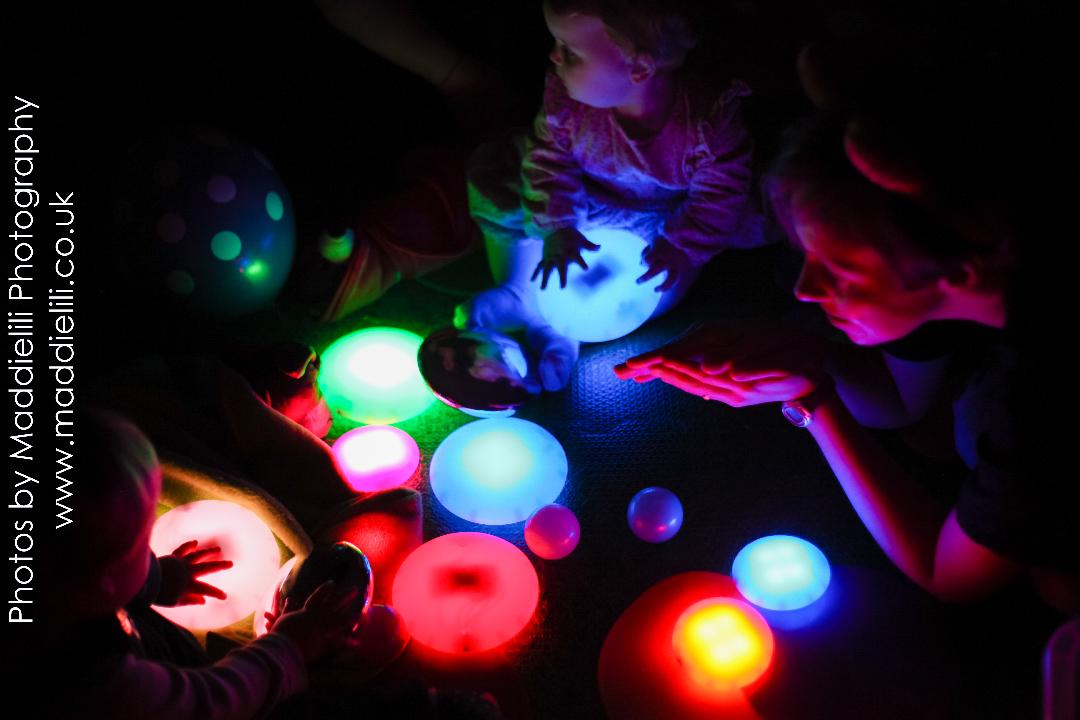 Babies at a Hartbeeps session playing with glow discs