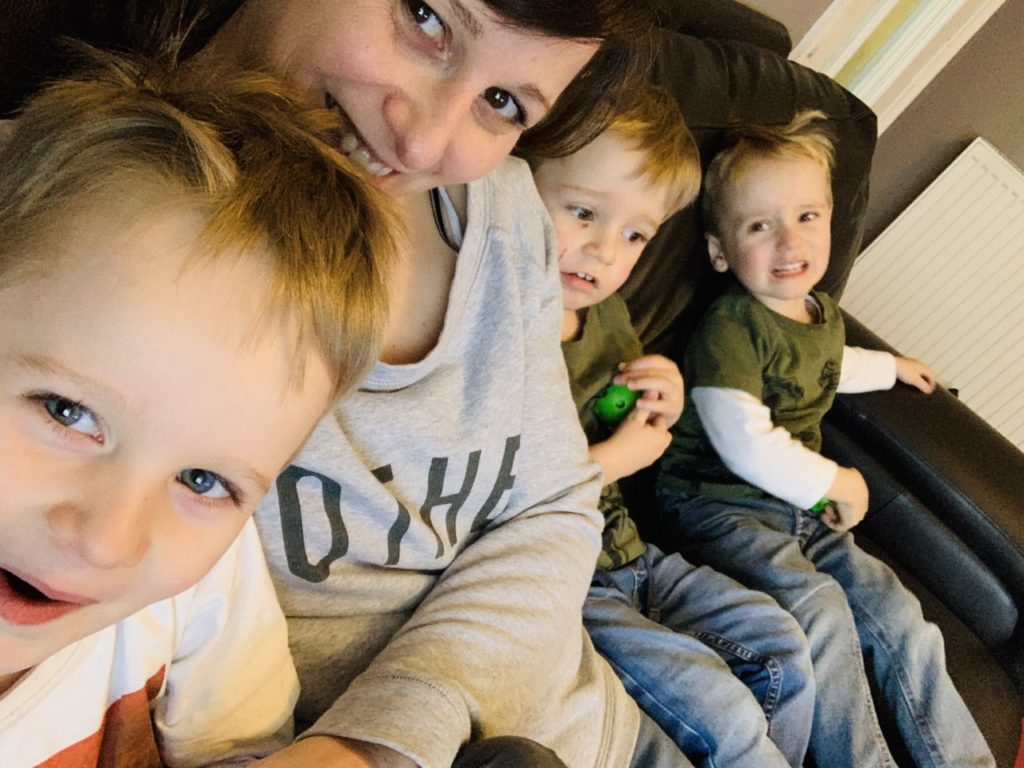 Mum and three young sons on the settee - how to keep toddlers entertained at home