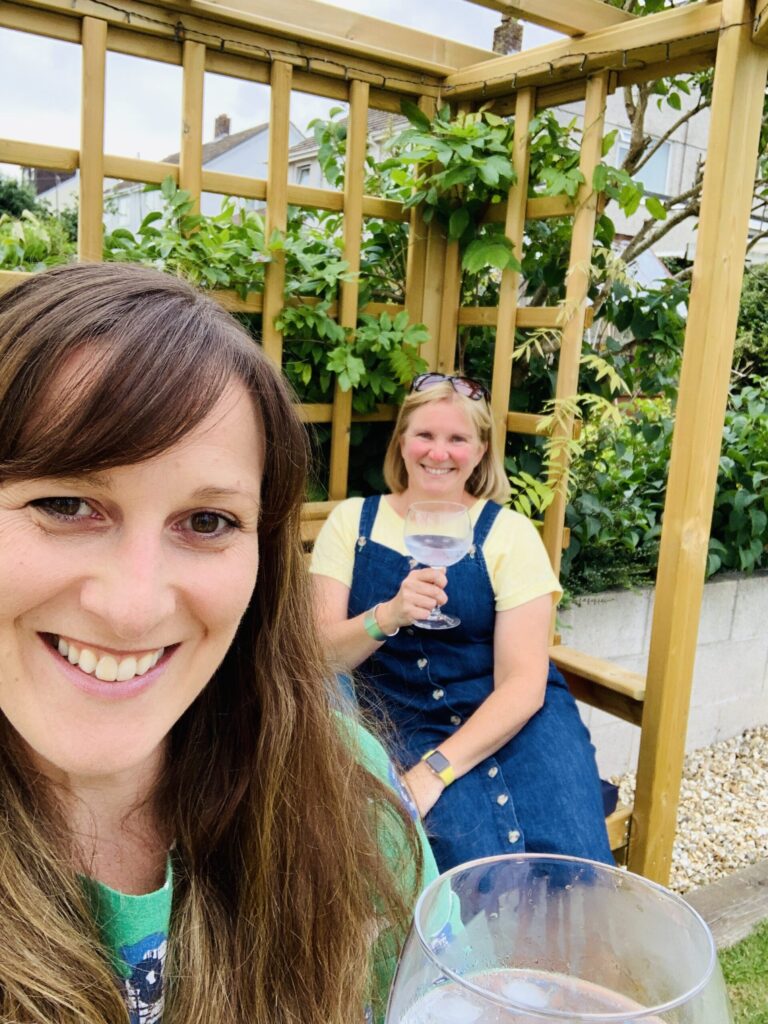 Two women drinking gin in the garden