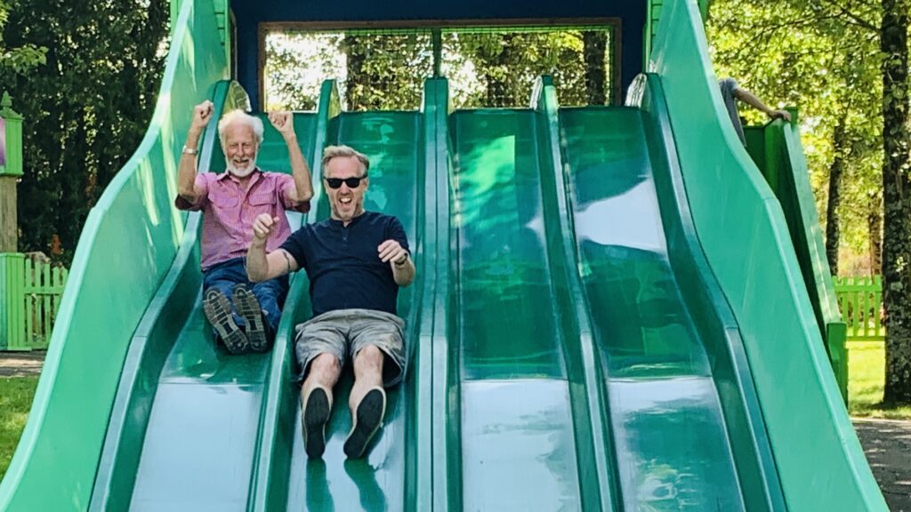 Grandad and Dad enjoying the bumpy slide at Camel Creek