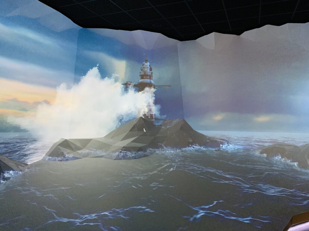 Digital image on a wall of Plymouth Sound and the waves crashing up against Eddystone lighthouse