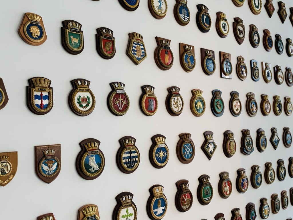 Naval badges cover a wall at the Box museum in Plymouth