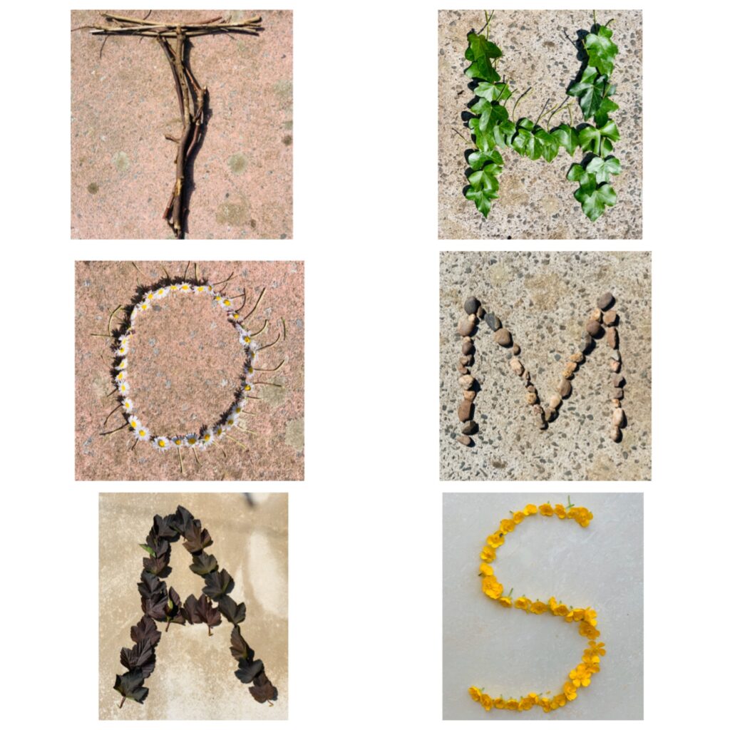 The letters THOMAS spelt out using different twigs, leaves, flowers and leaves from the garden