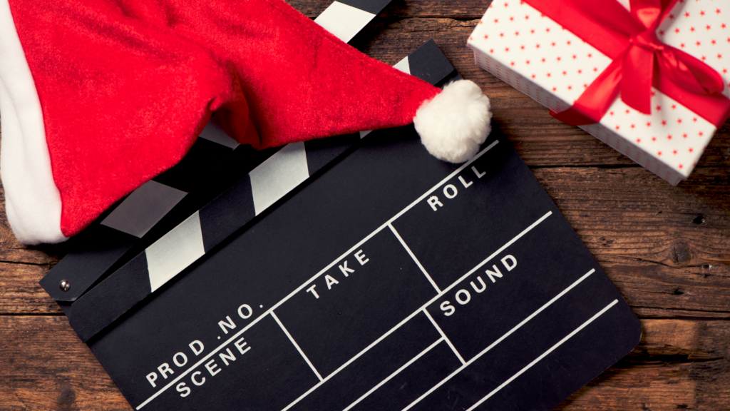 Movie Directors board, santa hat and christmas present for a post on Christmas movies for kids