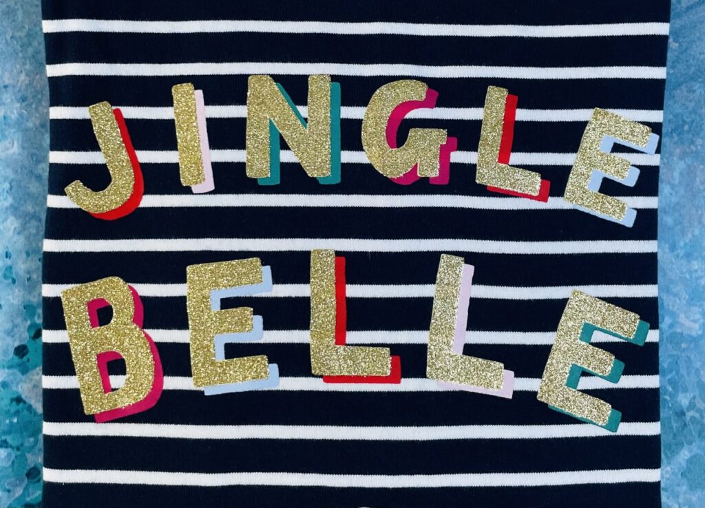 Glittery 'Jingle Belle' slogan on a navy and blue stripey t-shirt