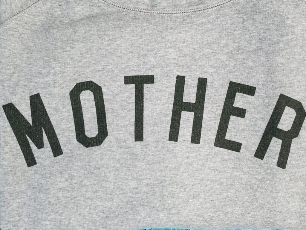 A black 'Mother' slogan on a sweatshirt