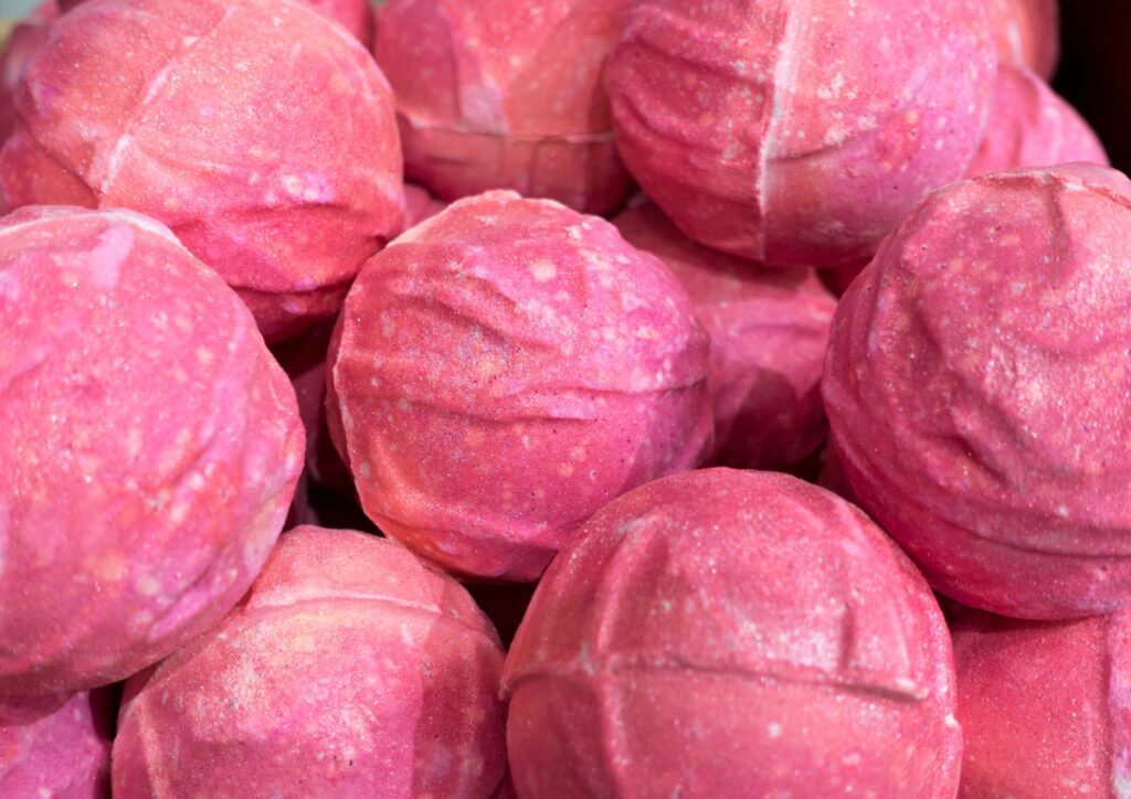 A pile of pink circular bath bombs. An idea for Christmas Eve Boxes.