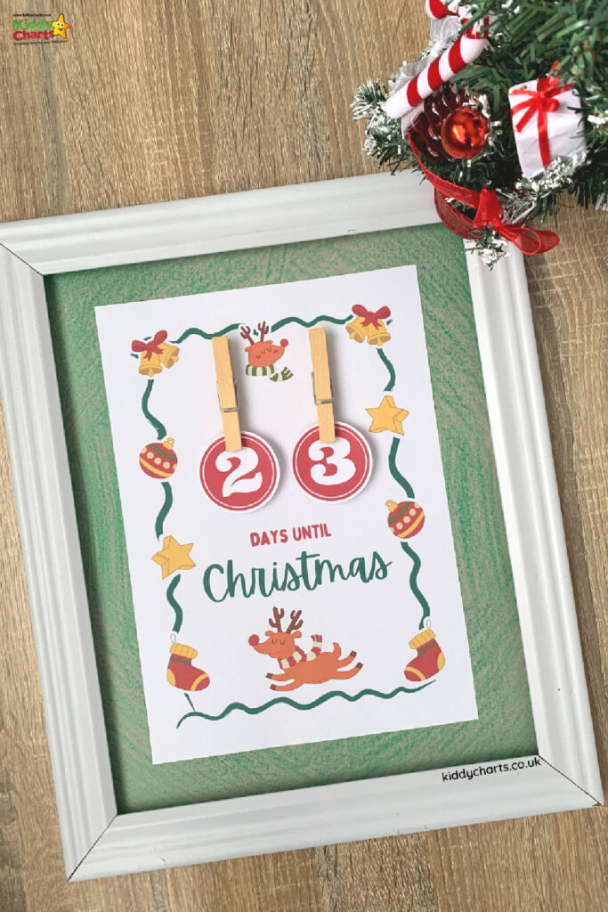 A homemade advent calendar in a frame with two circular numbers on it