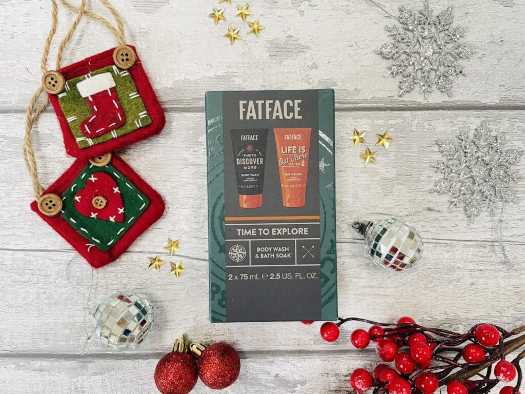 Fatface mini shower duo gift set from Boots surrounded by Christmas decorations on a grey background