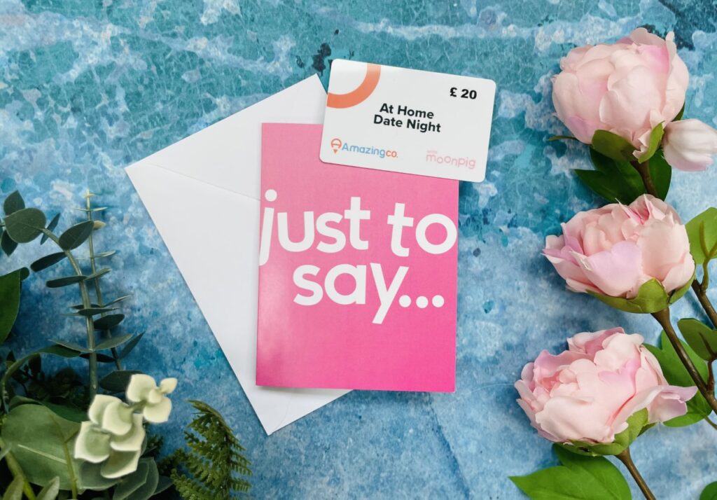 Pink 'just to say' card with a white voucher on a blue background for Valentine's Day in lockdown