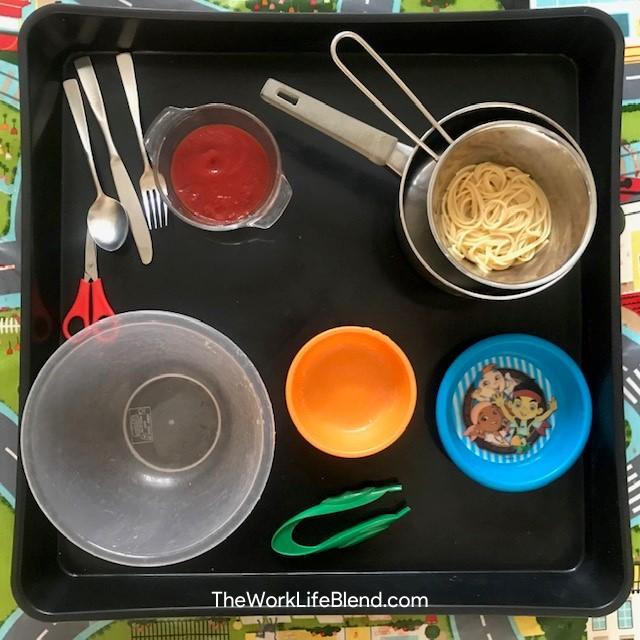 A tuff tray with various bowls on it for an activity to do in half term in lockdown