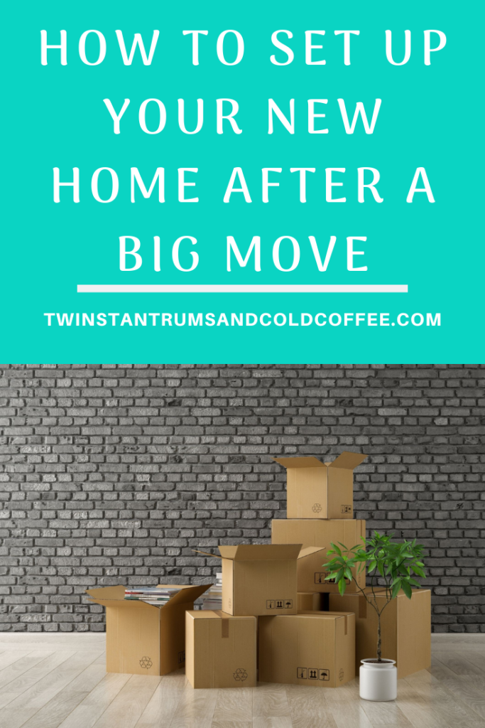 How to set up your new home after a big move with a pile of boxes against a brick wall in an empty room