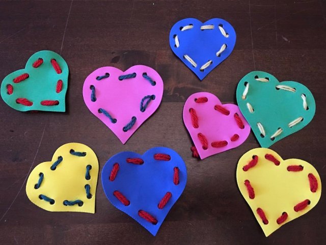 Colourful heart shaped cards with wool threaded through