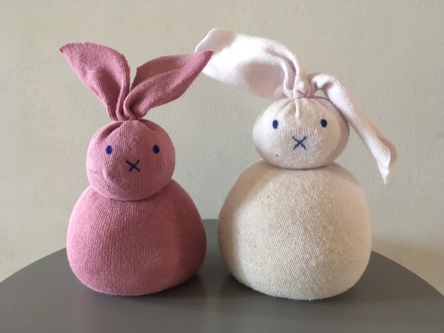 Two pink bunnies made out of socks filled with rice