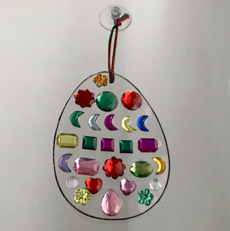 An easter egg suncatcher with different coloured jewels is a great easter craft idea for kids