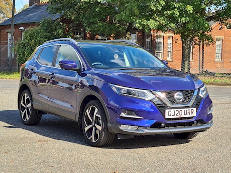 A blue nissan second hand car for sale on a driveway