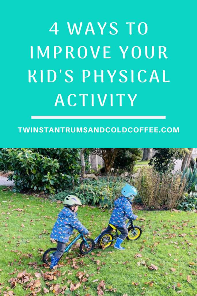 Twin three year old boys on balance bikes on grass as a way to improve your kid's physical activity