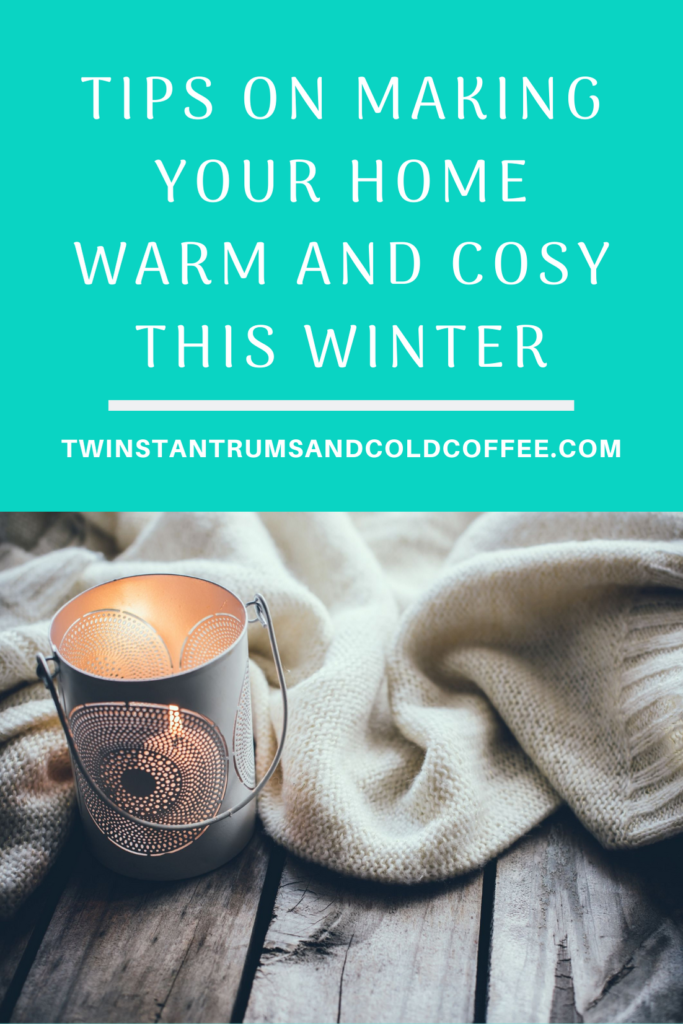 A candle and blanket on a surface as a way of making your home warm and cosy this winter