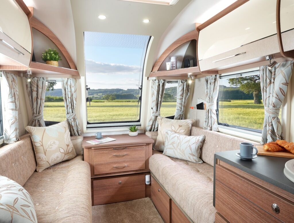 Inside a caravan showing the settee and living area you'd have on a caravan holiday