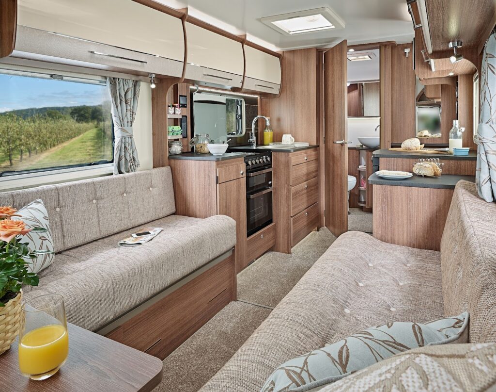 Inside a caravan showing the living area and kitchen