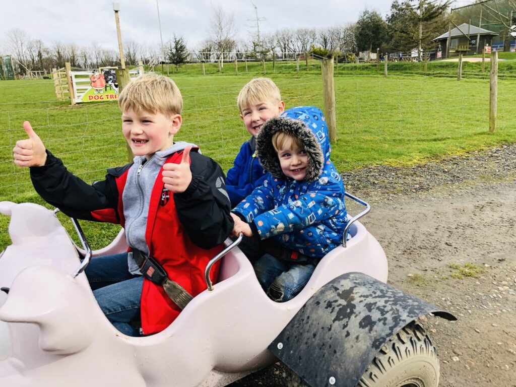 Three boys on a tractor ride