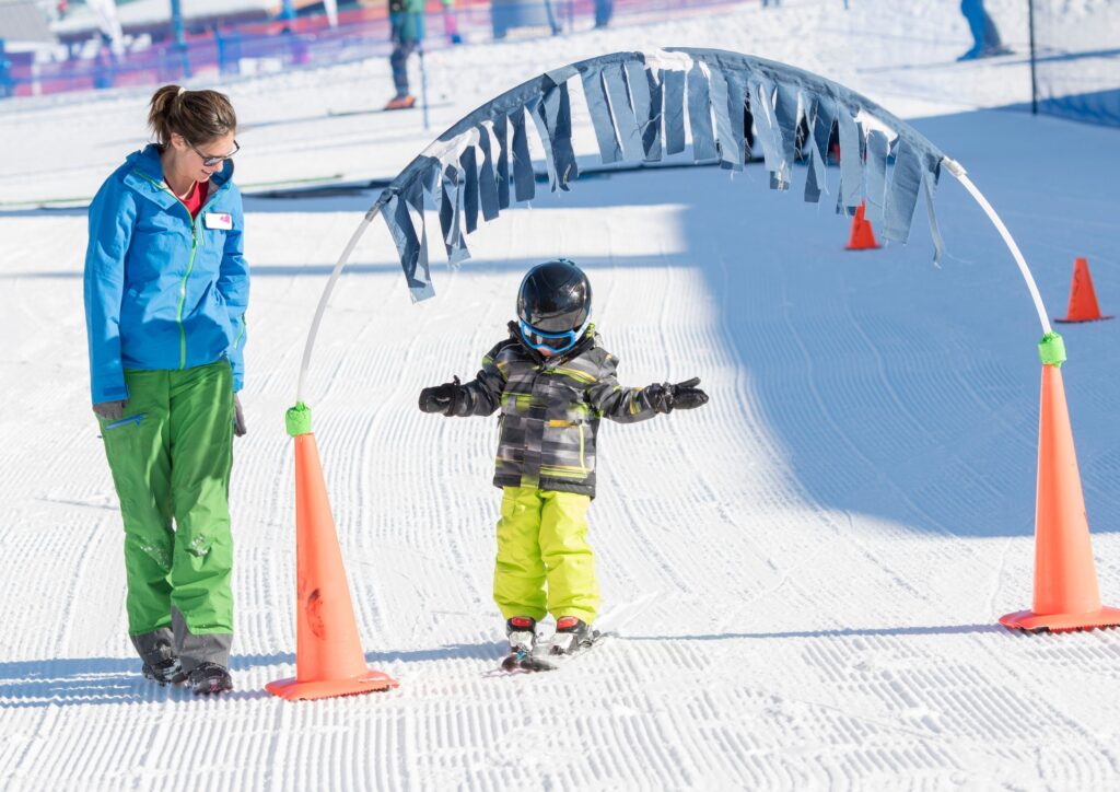 Ski instructor helps a three year old learn to ski for a piece about a ski holiday in Japan