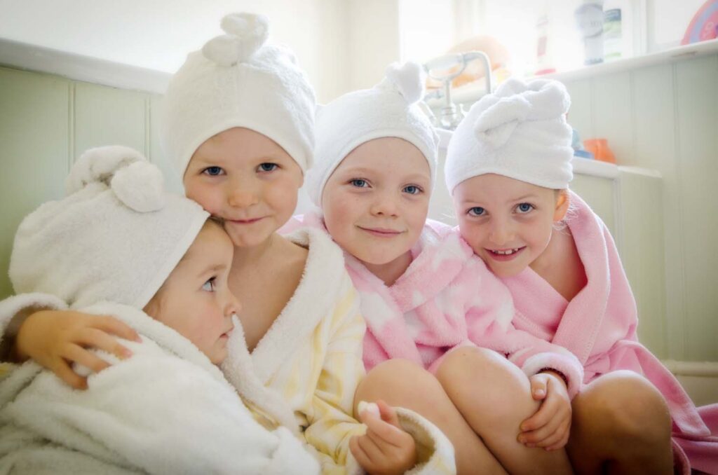 Four girls wear Cuddletwist towels to dry off their wet hair