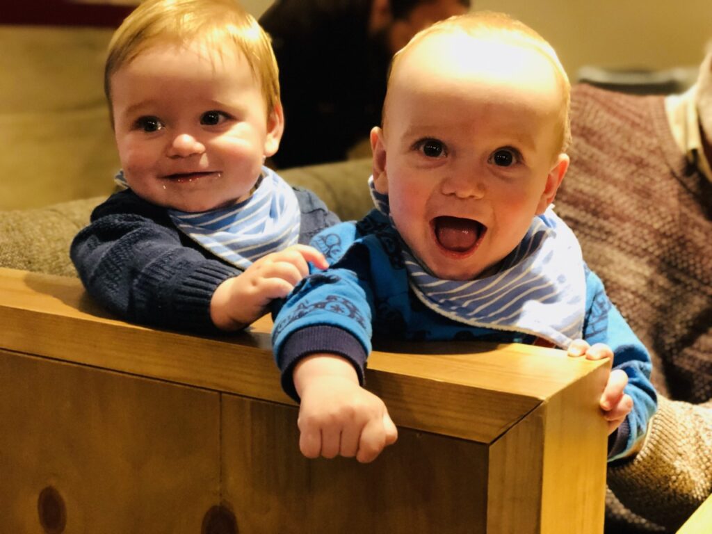 Nine month old twins in a cafe