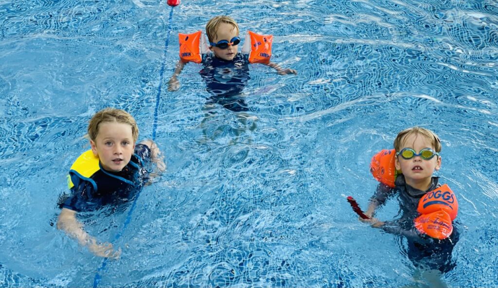 Three brothers in a swimming pool for a piece on summer safety tips