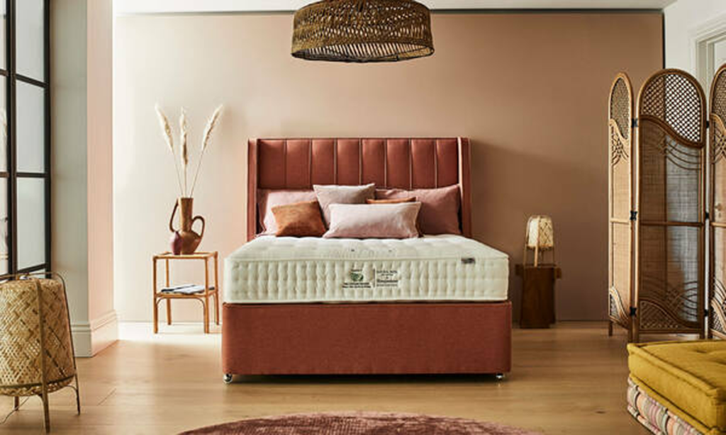 How to update your bedroom in autumn colours, a terracotta coloured bed with autumn coloured walls