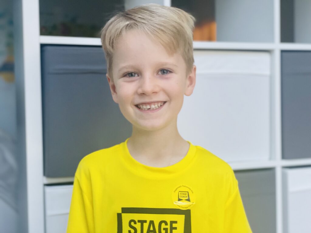 Six year old boy wearing a yellow Stagecoach t.shirt