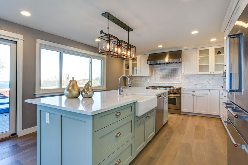 A kitchen with a large island and luxury vinyl flooring