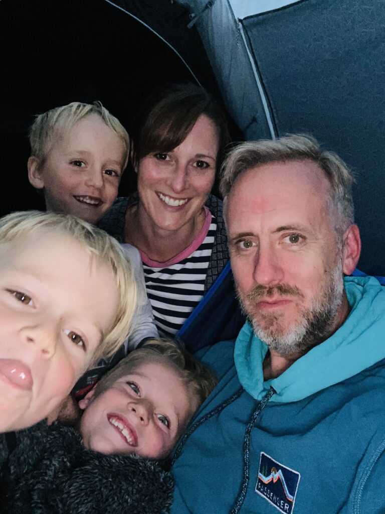 A family selfie inside a tent