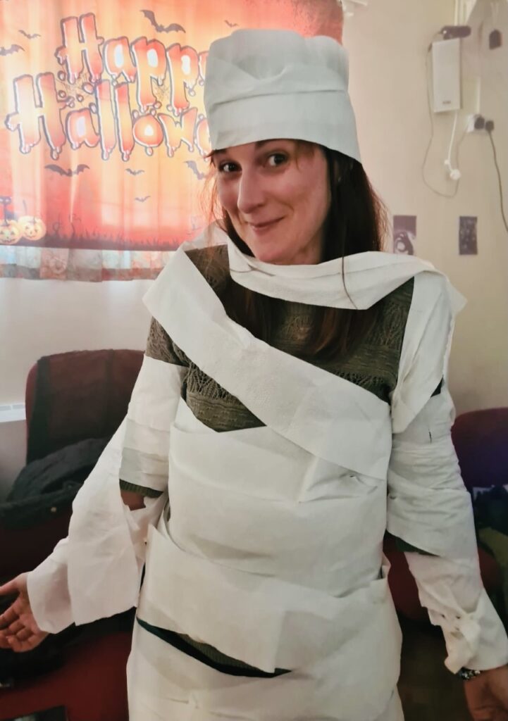 A mum dressed as a mummy wrapped in toilet roll for a Halloween game