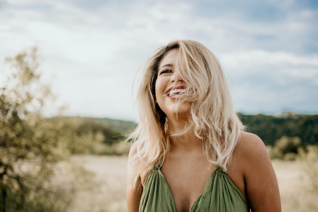 A blonde girl on a beach has high self esteem